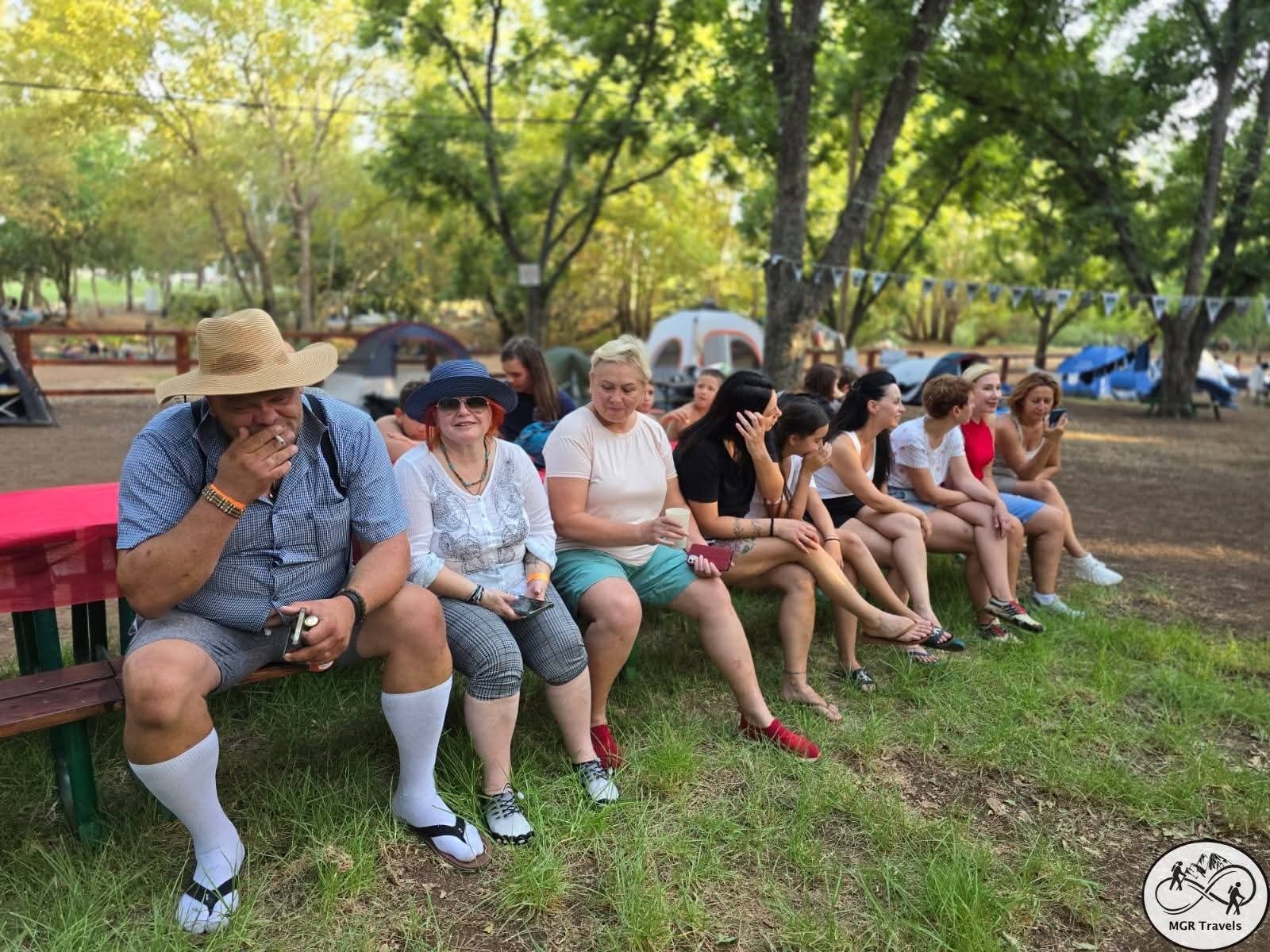 Friends taking a break together in the shade of trees