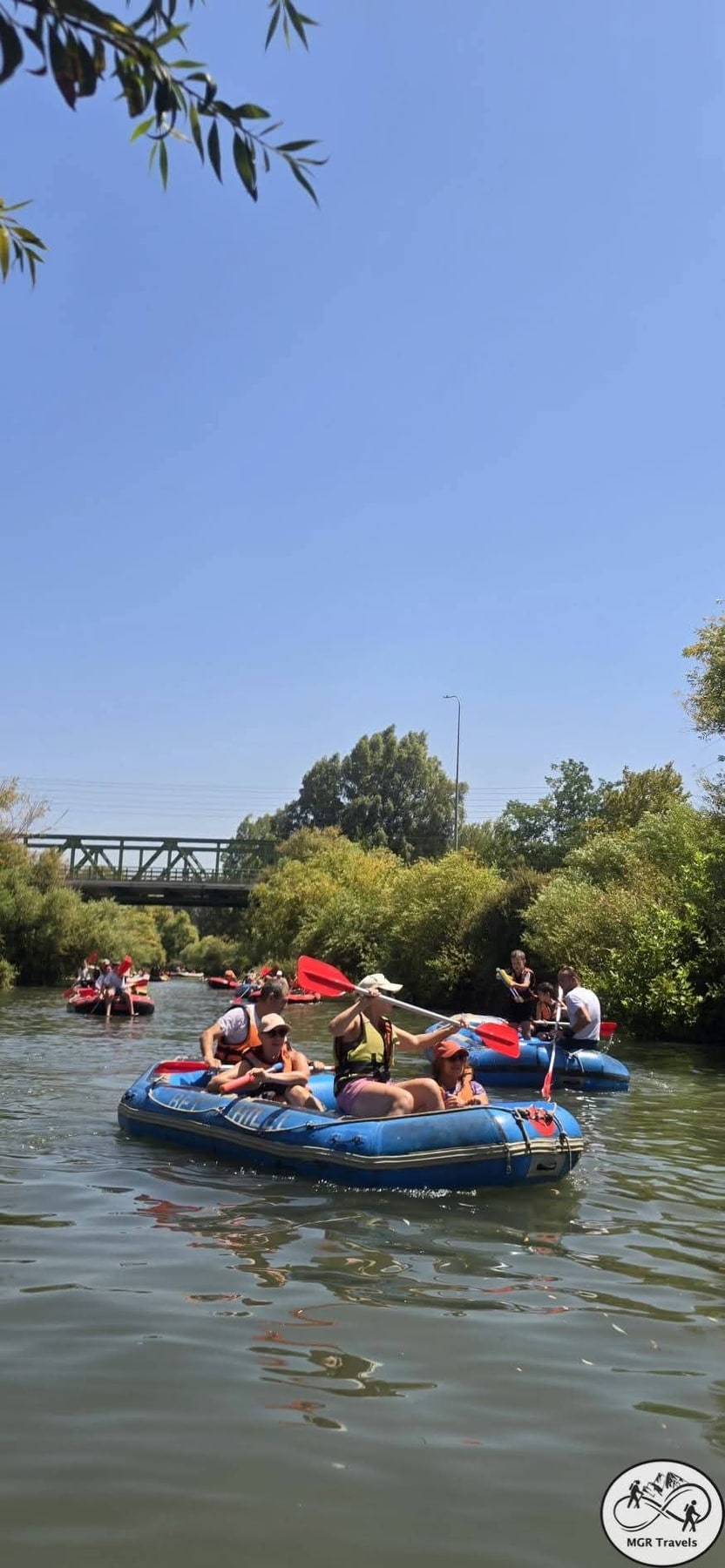 Friends on a raft beneath a bright summer sky